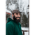 A smiling, laughing, bearded man standing outside in the winter with a building in the background. Man is wearing an Original Stormy Kromer cap in a brown plaid and a dark green hooded pullover.
