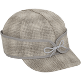 A 45 degree angle view of The Ida Kromer Cap: a wool, six-panel winter cap with a pulldown earband that ties in front and has a brim.