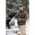 Photo of a man standing at the gate of his pick up truck in the winter with snow on the ground and evergreen trees in the background. A black labrador retriever is sitting on the down gate of the truck and the man is petting him. The man is wearing a camouflage Stormy Kromer Waxed Cotton Cap and Vest, with brown pants and a brown shirt. The dog is wearing a matching jacket.