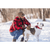 Photo of man and his white and brown pit bull terrier mix dog in the snow with trees in the background. Man is crouched down petting the dog. Man is wearing Stormy Kromer Waxed Rancher Cap, red and black plaid Mackinaw Coat and jeans.