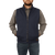 On model front view of the Ironwood Vest: A zip front wool vest with a stand collar and side pockets. Model has hands in pockets.