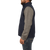On model side view of the Ironwood Vest: A zip front wool vest with a stand collar and side pockets.