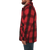 On model, side view of the Mackinaw Coat: A collared, button-front wool coat with six large pockets on the front. The model has their hands in the side pockets.