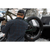 Photo from the back of a man putting his fat tire back in the back of a pick up truck. He is wearing a dark blue and green plaid Camp Shirt Jack and a wool baseball cap.