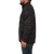On model side view of the Boundary Jacket: A zip-front, wool-plaid men's jacket with a stand collar and side pockets.