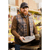 Photo of a man in an old-fashioned hardware store holding a scale for weighing nails. He is wearing a gray plaid wool ballcap, a brown quarter zip and a North Star Plaid Button Vest.