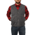 On model front view of the Waxed Cotton Vest with Lining: A traditional button front vest with large front patch pockets. Vest is made of waxed cotton and lined in plaid. Model has hands in pockets.