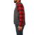 On model side view of the Waxed Cotton Vest with Lining: A traditional button front vest with large front patch pockets. Vest is made of waxed cotton and lined in plaid.
