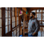 Photo of bearded man looking out a wall of windows while wearing The Wool Shirt in Slate.