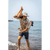 Image of a father playing with his son and holding him upside down on the beach. Father is wearing a light colored Forager Hat and plaid shirt, the son is also wearing a ball cap.