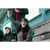 Image of a woman sitting in bleachers and cheering. She is wearing a dark charcoal Fleece Beanie, a gray shirt and a red/black plaid vest.