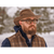 Man with glasses wearing a brown, waxed Backwoods Cruiser hat outside with a snowy background.
