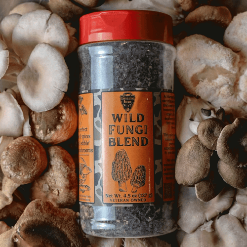 Harvesting Nature Wild Fungi Sprice Blend in a bottle laying on top of mushrooms