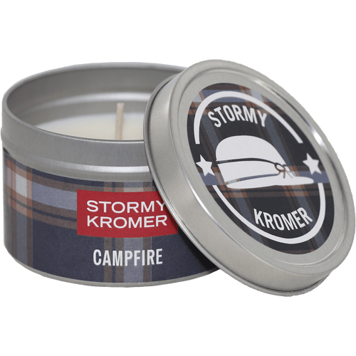 Tin jar candle from Kalamazoo Candle with a blue and rust plaid lid and band with Stormy Kromer logo
