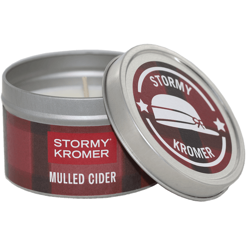 Tin jar candle from Kalamazoo Candle with a red plaid lid and band with Stormy Kromer logo