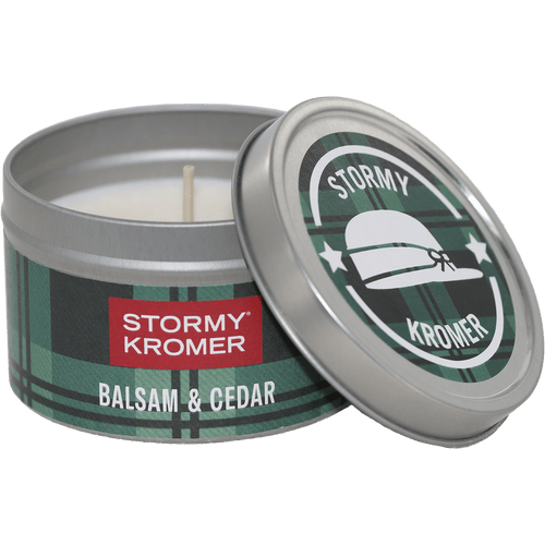 Tin jar candle from Kalamazoo Candle with a green plaid lid and band with Stormy Kromer logo