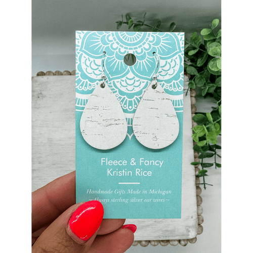 Pair of tear drop shaped earrings made of a leather backed cork which look like white birch bark
