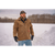 Bearded man standing outside in the winter wearing a brown waxed Squall Coat, mittens and waxed cap.